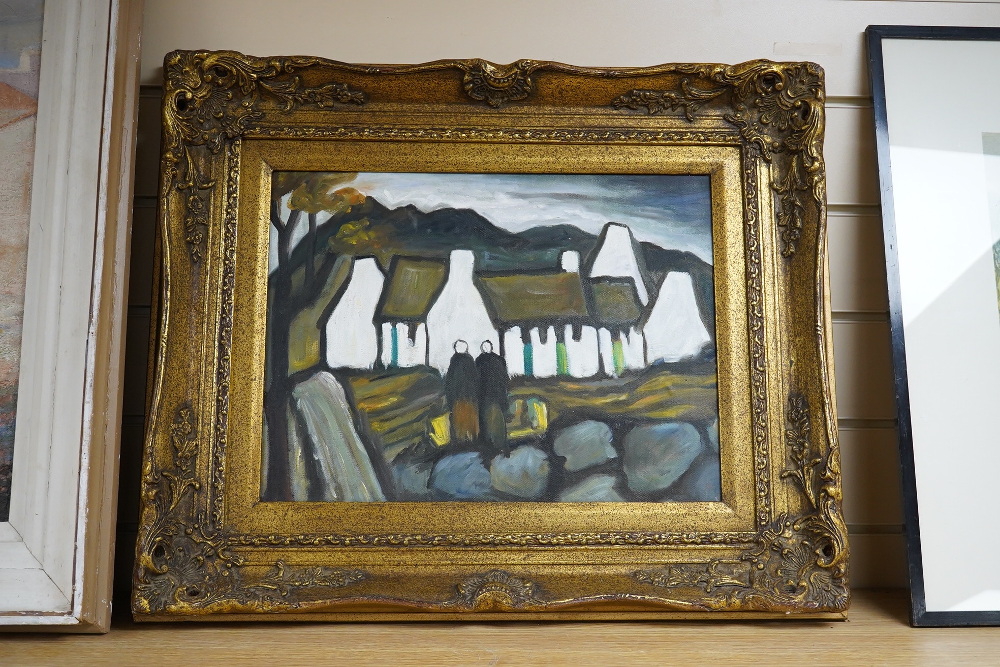 A decorative Irish School oil on board, Figures before cottages, 29 x 39cm, ornate gilt frame. Condition - good